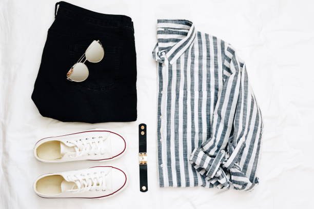 clothing items on a light background, sneakers, shirt and black jeans 1